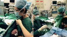 Nurse breastfeeds crying infant during surgery