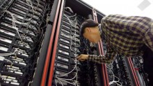 An employee working inside a supercomputer.