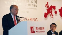 WH Group Executive Director, Chairman and Chief Executive Officer Wan Long (L) addresses as Executive Director and Vice President Yang Zhijun looks on during a news conference on the company's IPO in Hong Kong April 14, 2014.