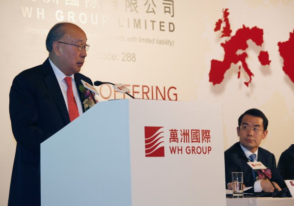 WH Group Executive Director, Chairman and Chief Executive Officer Wan Long (L) addresses as Executive Director and Vice President Yang Zhijun looks on during a news conference on the company's IPO in Hong Kong April 14, 2014.