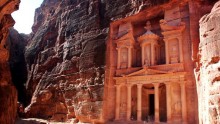 Tourists stand at the base of the 'Treasury of the Pharoah', a tomb, at the Petra archaeological site November 23, 2002 in Petra, Jordan