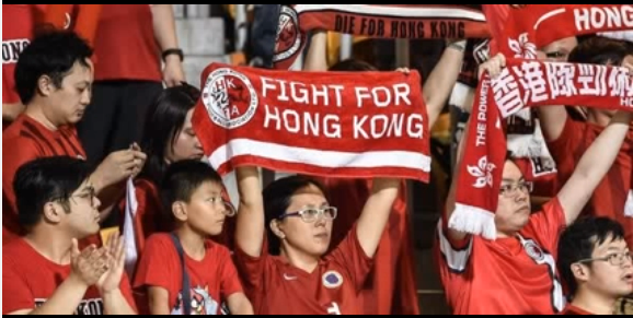 Hong Kong Football Fans holding placards against China