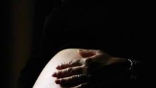 A Pregnant Woman Holds Her Stomach