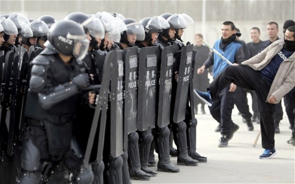 Xinjiang police participate in a mock riot exercise.