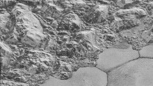 The Mountainous Shoreline of Sputnik Planum: In this highest-resolution image from NASA’s New Horizons spacecraft, great blocks of Pluto’s water-ice crust appear jammed together in the informally named al-Idrisi mountains.