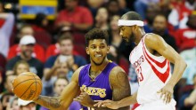 Los Angeles Lakers forward Nick Young drives past Houston Rockets' Corey Brewer
