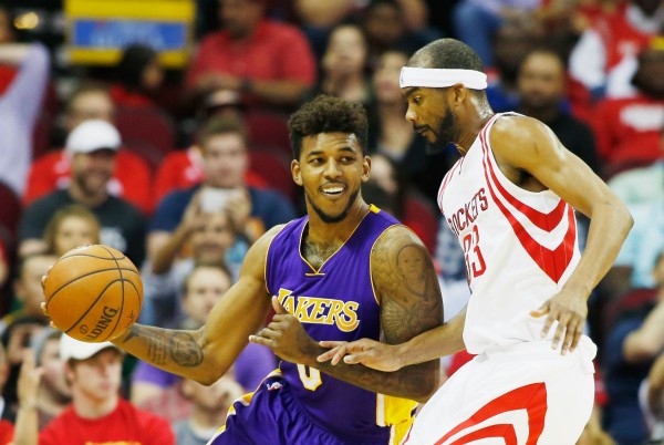 Los Angeles Lakers forward Nick Young drives past Houston Rockets' Corey Brewer