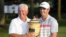 Rory McIlroy and father Gerry receiving the Bridgestone Invitational cup following his two stroke victory