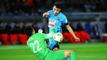 FC Barcelona forward Munir El Haddadi shoots against Guangzhou Evergrande goalkeeper Li Shuai