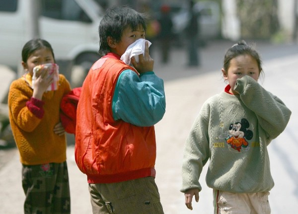 Children covering their nose because of the obnoxious smell lingering around the neighborhood