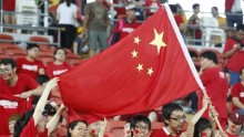 China fans wave the national flag before the Asian Cup quarter-final soccer match between China and Australia at the Brisbane Stadium