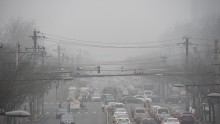 Cars drive below a blanket of smog on a heavily polluted day in Beijing 