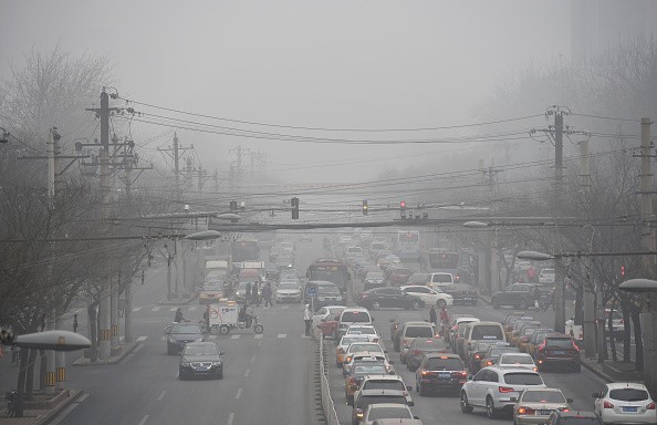 Cars drive below a blanket of smog on a heavily polluted day in Beijing 