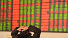 An investor observes the stock market at an exchange hall on January 13, 2016 in Fuyang, Anhui Province of China.