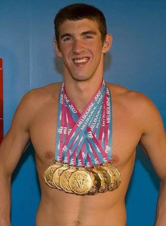 Michael Phelps proudly shows his gold medals at the 2008 Beijing Olympics