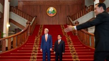 US Secretary of State John Kerry (L) stands with Laos Prime Minister Thongsing Thammavong after their meeting at the prime minister's office in Vientiane on Monday.