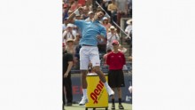 A jubilant Novak Djokovic jumping and throwing his fist in the air after defeating Gael Monfils in a three set thriller