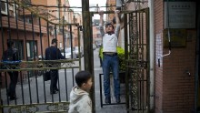 A Uighur man does a pull-up in Shanghai.