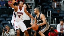 Atlanta Hawks center Al Horford guards San Antonio Spurs point guard Tony Parker