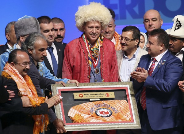 Turkey's Prime Minister and presidential candidate Tayyip Erdogan poses with representatives of nomadic Turkish groups in Ankara August 6, 2014. 