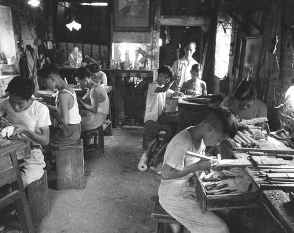 Young boys carving ivory for the tourist trade at a shop in Hong Kong. 