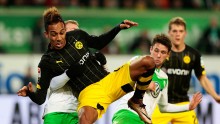Borussia Dortmund striker Pierre-Emerick Aubameyang (middle) competes for the ball against two Wolfsburg defenders