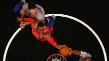 Brooklyn Nets' Brook Lopez and Thaddeus Young rebound against Houston Rockets center Dwight Howard