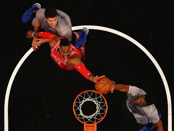 Brooklyn Nets' Brook Lopez and Thaddeus Young rebound against Houston Rockets center Dwight Howard