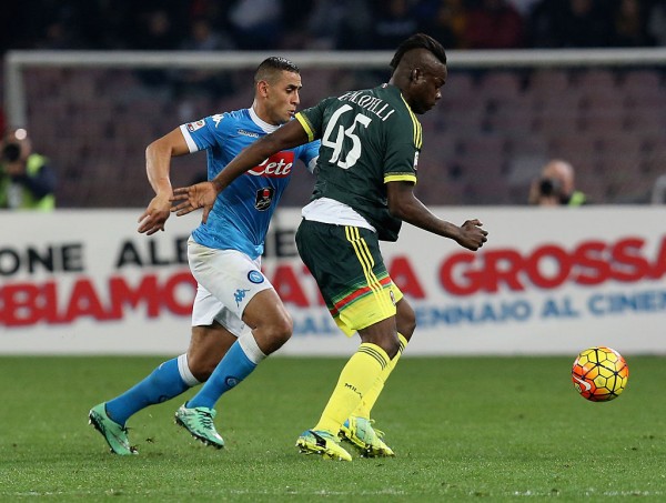 AC Milan striker Mario Balotelli competes for the ball against SSC Napoli's Faouzi Ghoulam