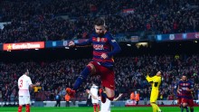 Barcelona defender Gerard Pique jumps after scoring his team's second goal against Sevilla