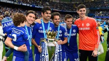 Chelsea players (from L to R) Filipe Luis, Diego Costa, Cesc Fabregas, Cesar Azpilicueta, and Thibaut Courtois celebrate with the Premier League trophy last season