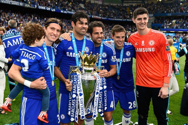 Chelsea players (from L to R) Filipe Luis, Diego Costa, Cesc Fabregas, Cesar Azpilicueta, and Thibaut Courtois celebrate with the Premier League trophy last season