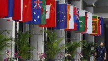 A police officer walks past the national flags of countries attending the Association of Southeast Asian Nations (ASEAN) Ministerial Meeting and ASEAN Regional Forum in Singapore in this July 2008 file photo.