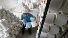 An employee packages rolls of yarn at a textile factory on May 8, 2013 in Jiujiang, China. (Photo: ChinaFotoPress/Getty Images)