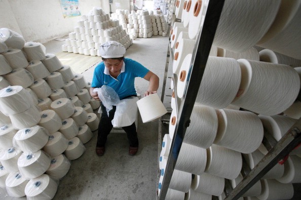 An employee packages rolls of yarn at a textile factory on May 8, 2013 in Jiujiang, China. (Photo: ChinaFotoPress/Getty Images)