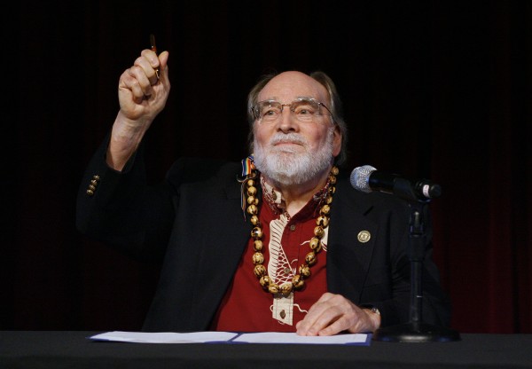 Hawaii Governor Neil Abercrombie holds up the pen after signing Senate Bill 1