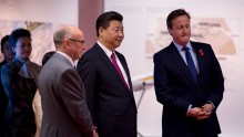  President of the People's Republic of China Xi Jinping and British Prime Minister David Cameron accompanied by the Chief Executive of The Manchester Airport Group, Charlie Cornish (L) tour an exhibition of future developments at Manchester airport on Oct