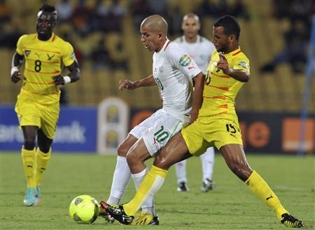 Algeria's Sofiane Feghouli (front L) and Togo's Alaixys Romao battle for the ball during their African Nations Cup Group D soccer match in Rustenburg January 26, 2013.