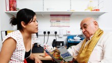 Asian female Clinical Nutrition and Dietetics Manager discussing diet with Asian male person with diabetes