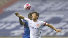 Yanbian Funde defender Cui Min competes for the ball against Shanghai Shenhua's Demba Ba during their 2016 CSL season opener