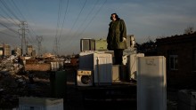 A Chinese laborer stands on a truck with appliances to be recycled in the Dong Xiao Kou village on Dec. 12, 2014 in Beijing, China. (Photo: Kevin Frayer/Getty Images)