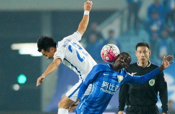 Jiangsu Suning midfielder Ramires (R) competes for the ball against Yanbian Funde's Pei Yuwen during their previous CSL match