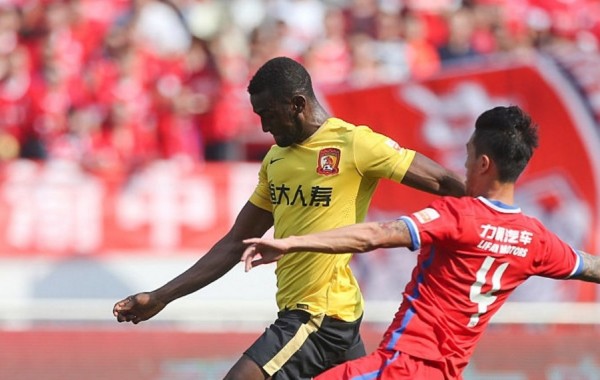 Guangzhou Evergrande striker Jackson Martinez competes for the ball against Chongqing Lifan's Luo Xin during their most recent CSL match