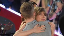 Taylor Swift hugs Calvin Harris at the iHeartRadio Music Awards.