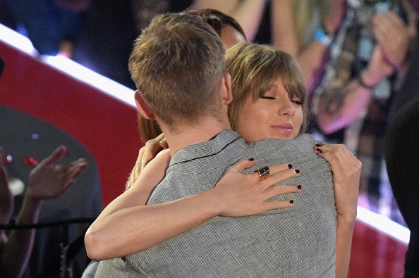 Taylor Swift hugs Calvin Harris at the iHeartRadio Music Awards.