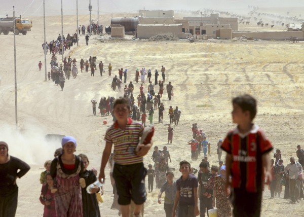 Displaced people from the minority Yazidi sect, fleeing violence from forces loyal to the Islamic State in Sinjar town.