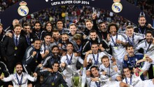 Real Madrid team members pose after winning the UEFA Supercup against Sevilla