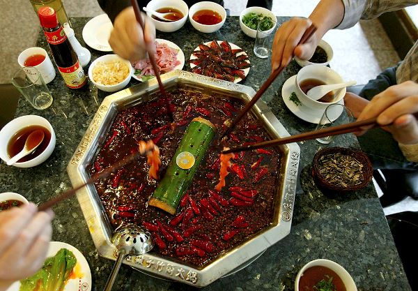 Chinese People Enjoy Hot Pot At A Restaurant