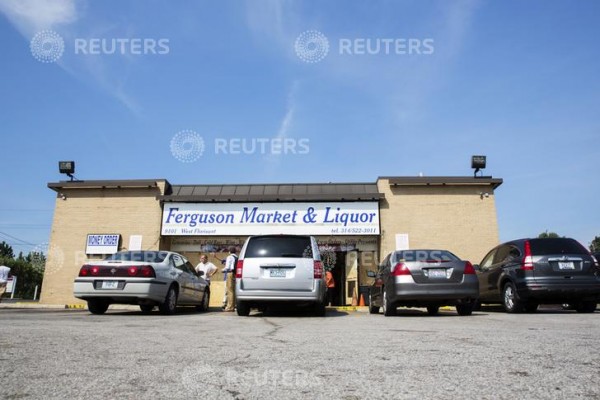 A local liquor store believed to be where police suspect Michael Brown was involved in the theft of cigars from the store minutes before police officer Darren Wilson shot him dead, stands open in Ferguson, Missouri August 15, 2014. 