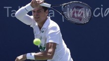Canadian Milos Raonic hits a forehand return against Fabio Fognini in the quarter-finals of the Western and Southern Open in Cincinnati